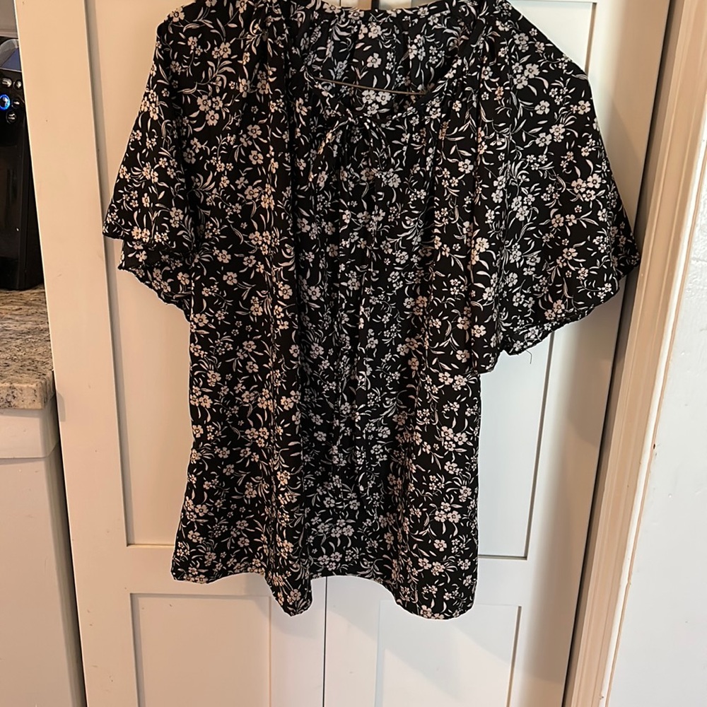 Multicolored small print blouse. Black with white and tan.  Tie neck.